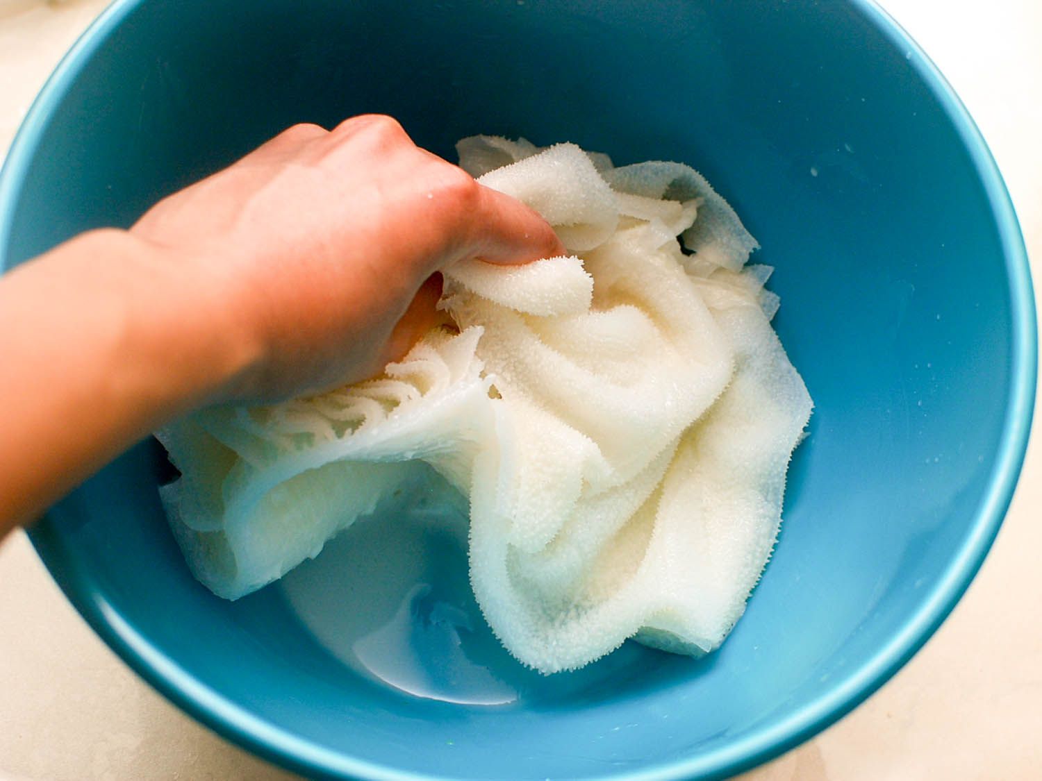 The tripe is massaged with the cornstarch-rice wine mixture.