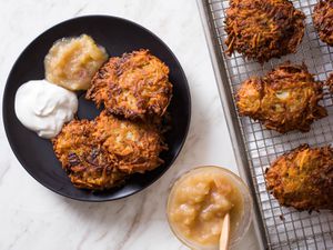 Latkes on a wire rack and three on a plate ready to serve 