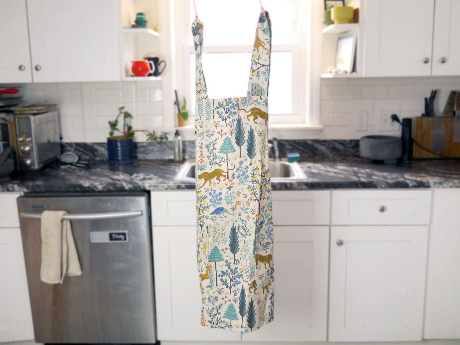 the hedley and bennett smock apron hanging up in a kitchen