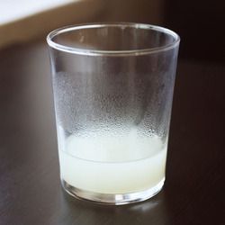 A glass of cloudy pasta cooking water.