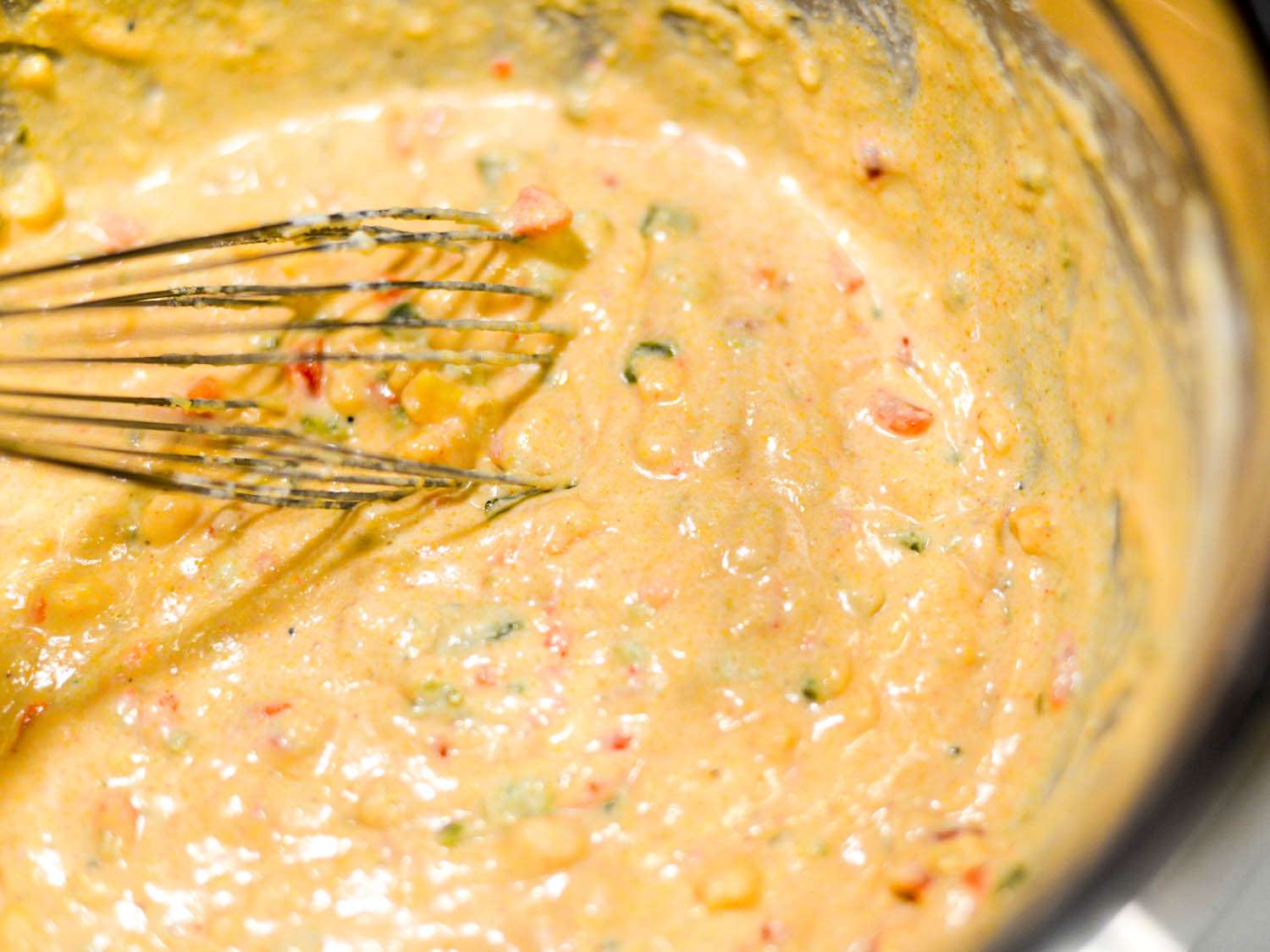 Whisking roasted pepper cornbread batter