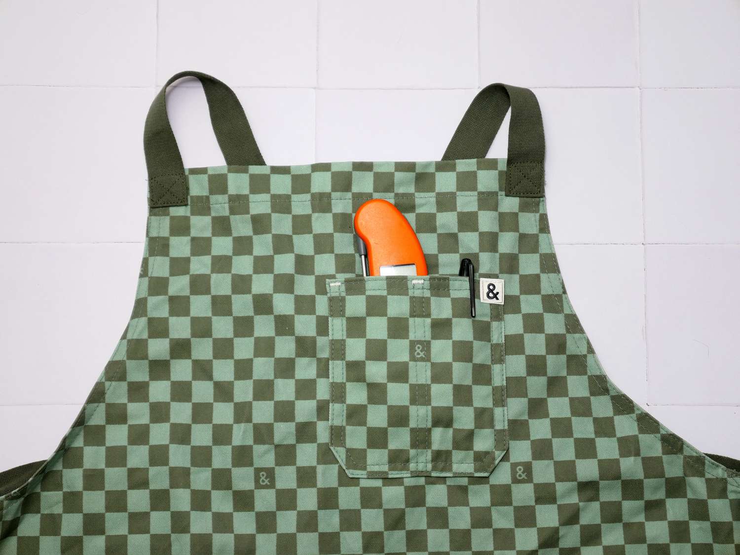 a closeup of the front pocket of the hexclad with a thermometer in it