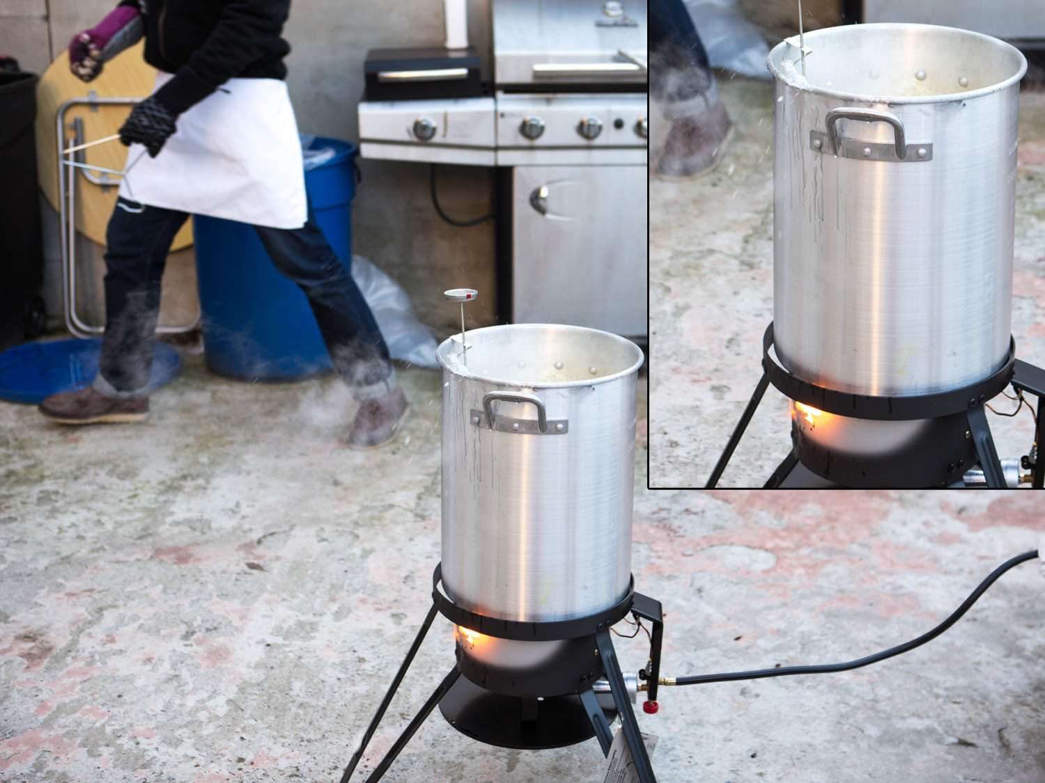Boiling fat shooting out of kettle in which turkey is being deep fried.