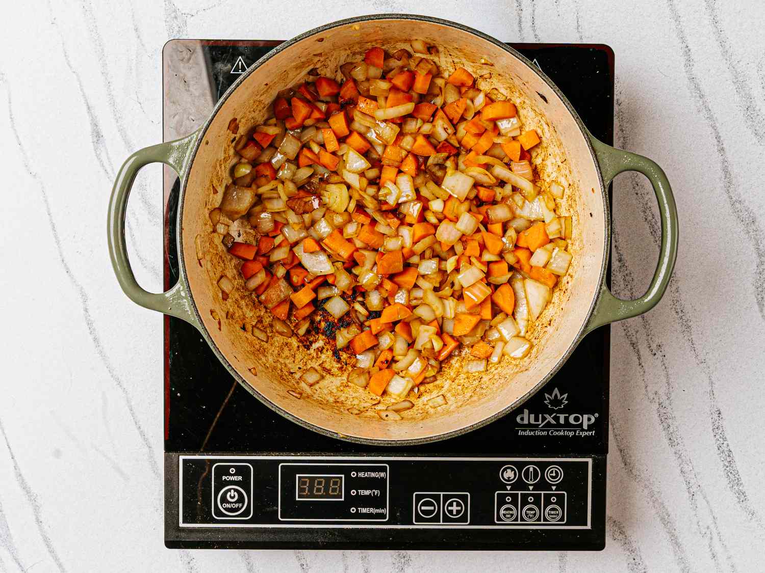 Vegetables sauting in a pot on an induction stove
