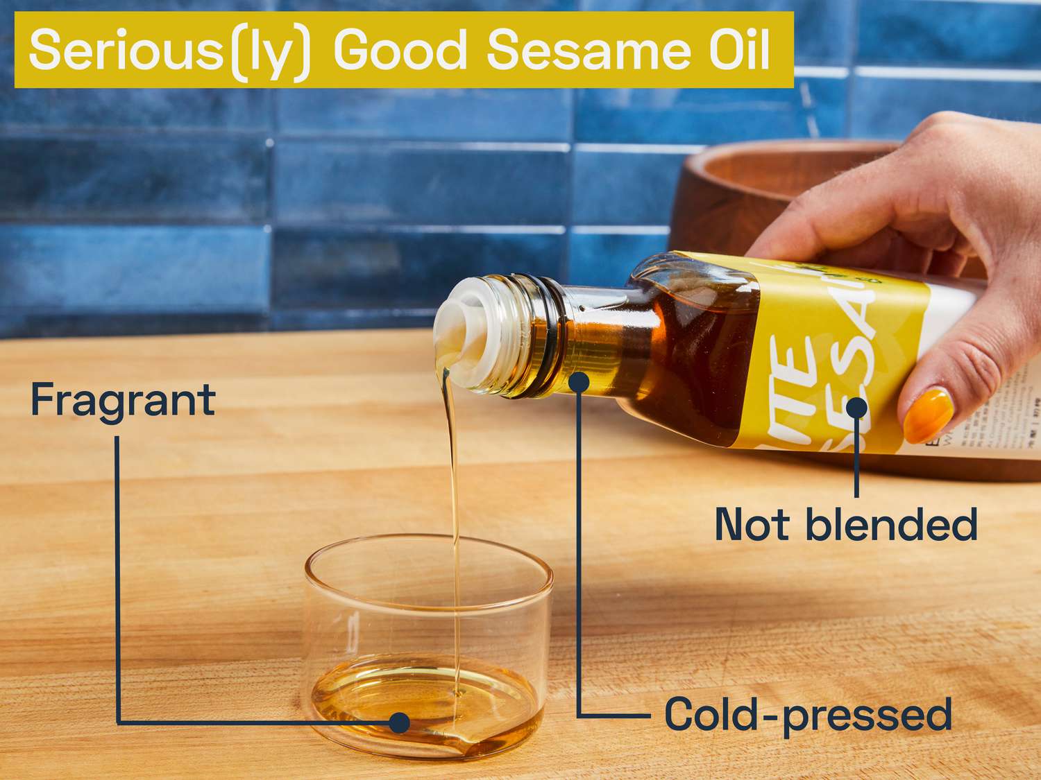 a bottle of white sesame oil being poured into a small glass cup