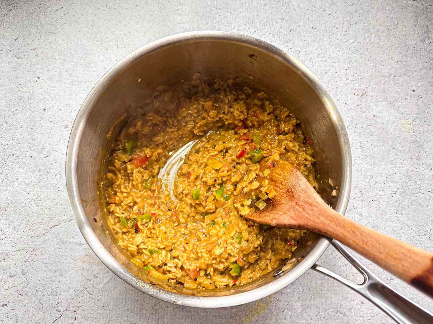 oats after thickening in pot, mixing with a wooden spoon 