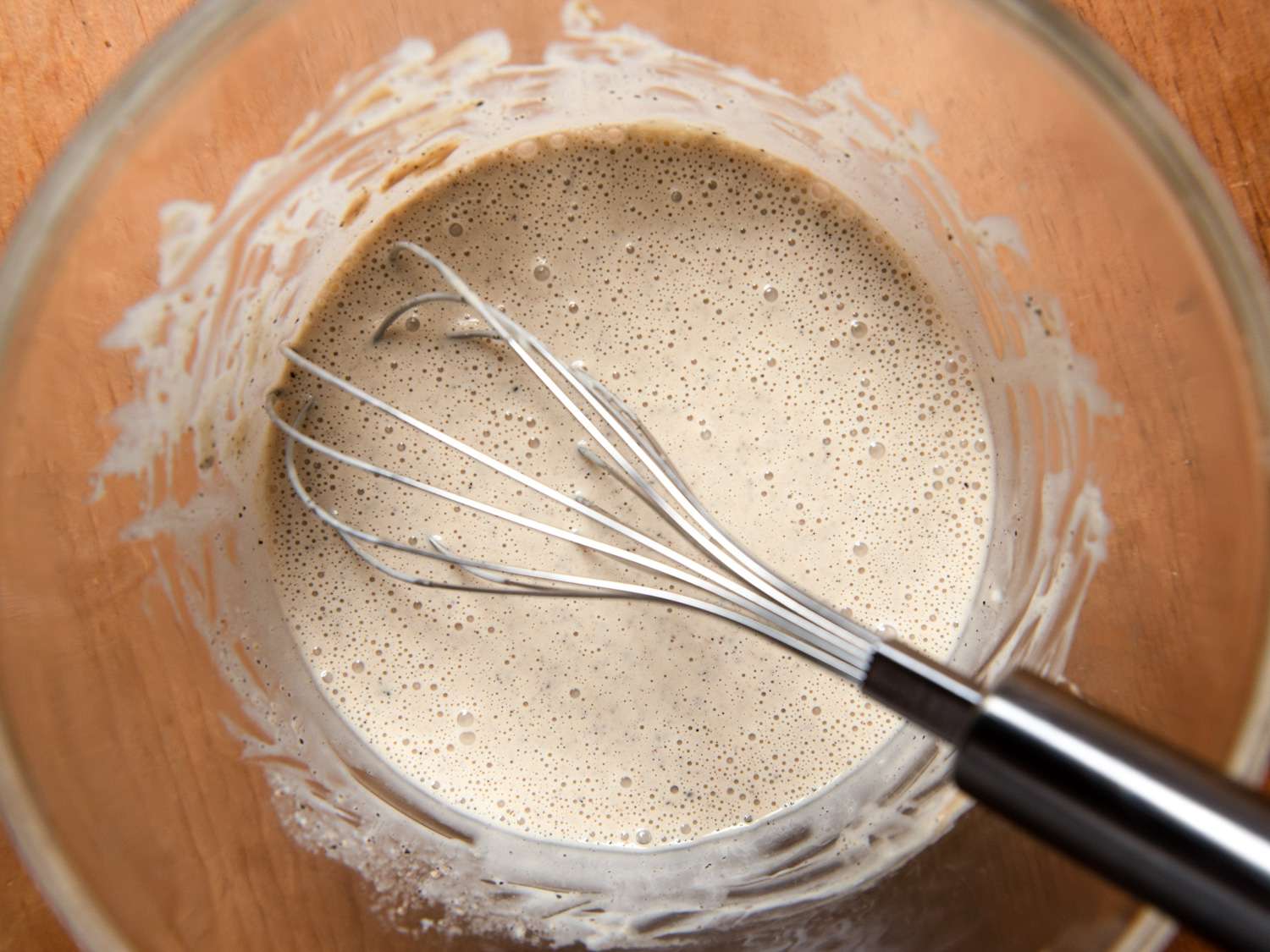 Whisking together ingredients for coleslaw dressing