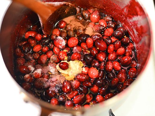 Cranberries and the rest of the sauce ingredients are brought to a simmer in a large saucepan.