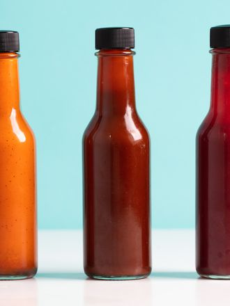 three different flavored fermented hot sauces in bottles
