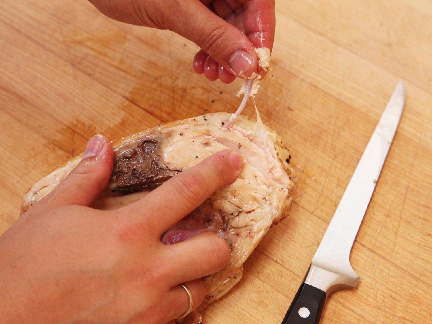 Removing wishbone from a chicken breast cooked sous vide and finished on the stovetop.