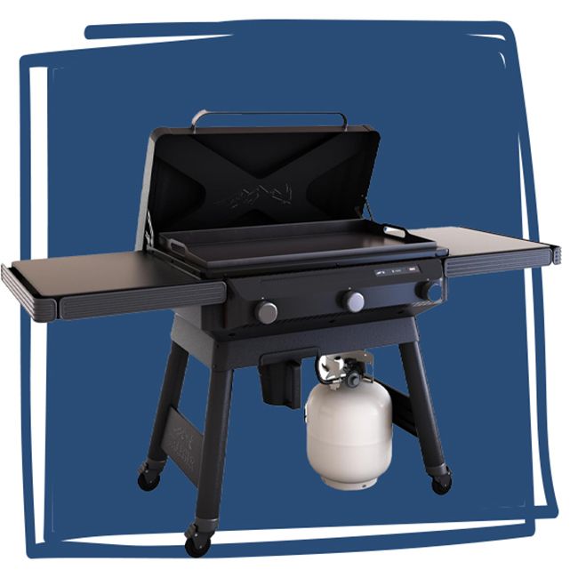 A Traeger Flatrock grill with a propane tank underneath and side shelves for extra space