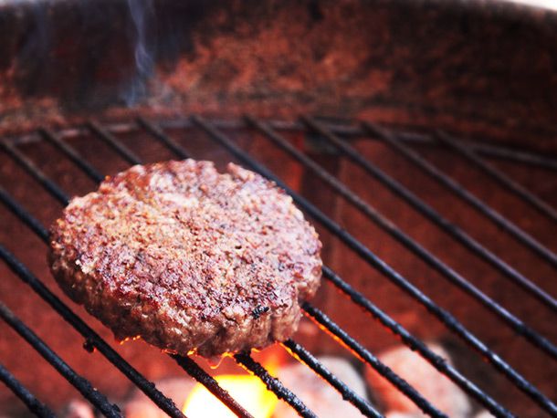 A burger on a grill.