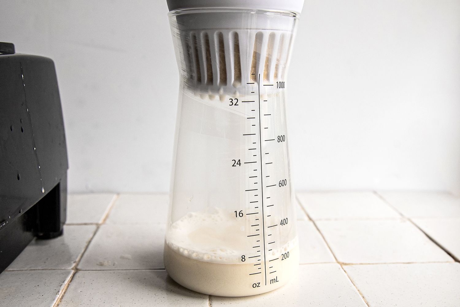 nut milk dripping into the carafe