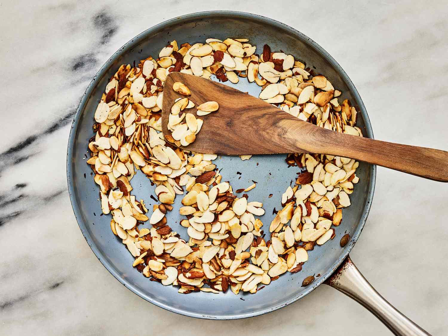 Almond slivers toasting in a pan
