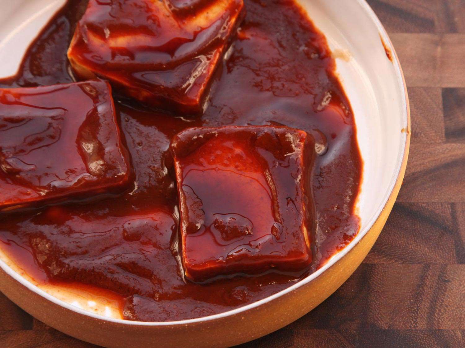 Tofu thawing and marinating in chile purée at the same time.