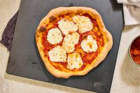 A baked pizza on a baking steel.