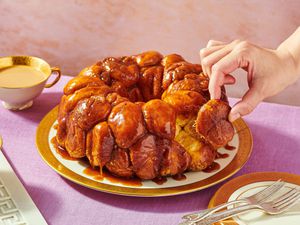 Monkey bread on a plate, person lifting a piece