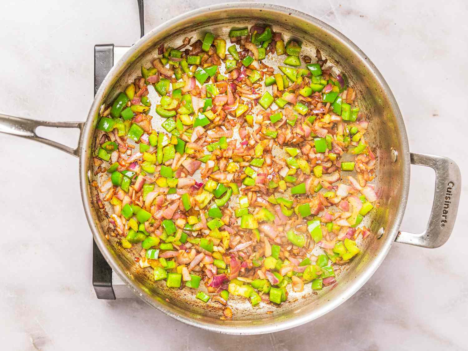 Overhead view of cooking onions and vegetables