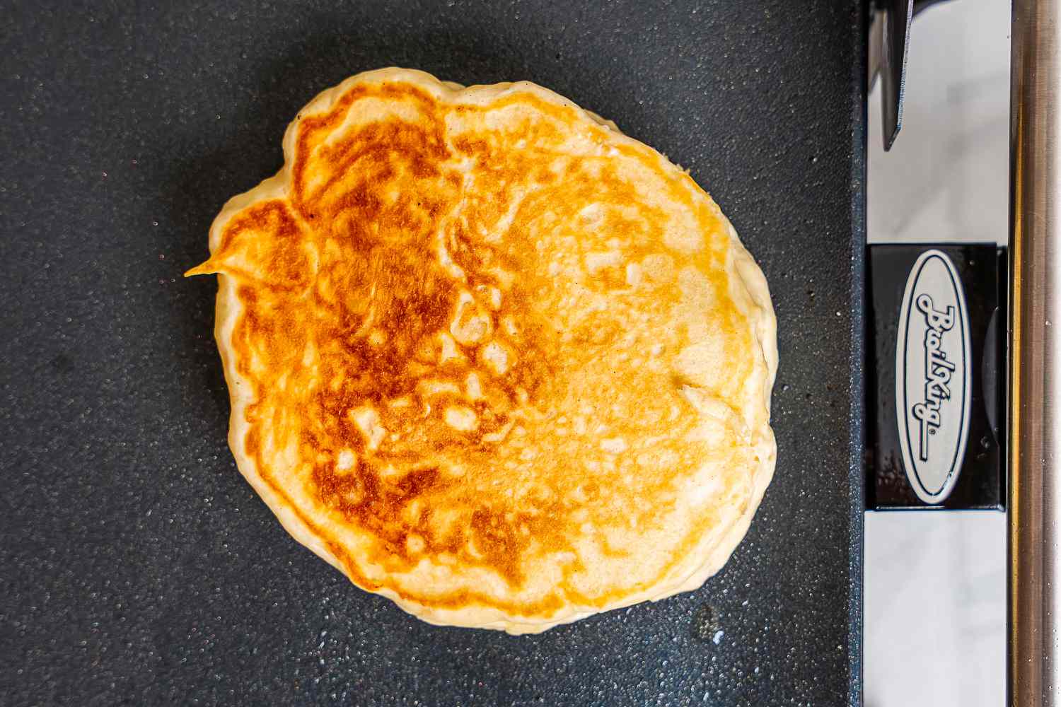 A pancake cooking on the Broil King electric griddle