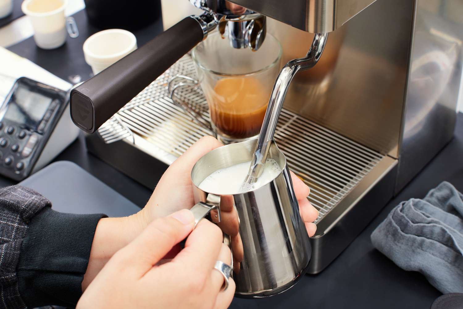 A person using the milk frother on the Lelit Elizabeth Espresso Machine