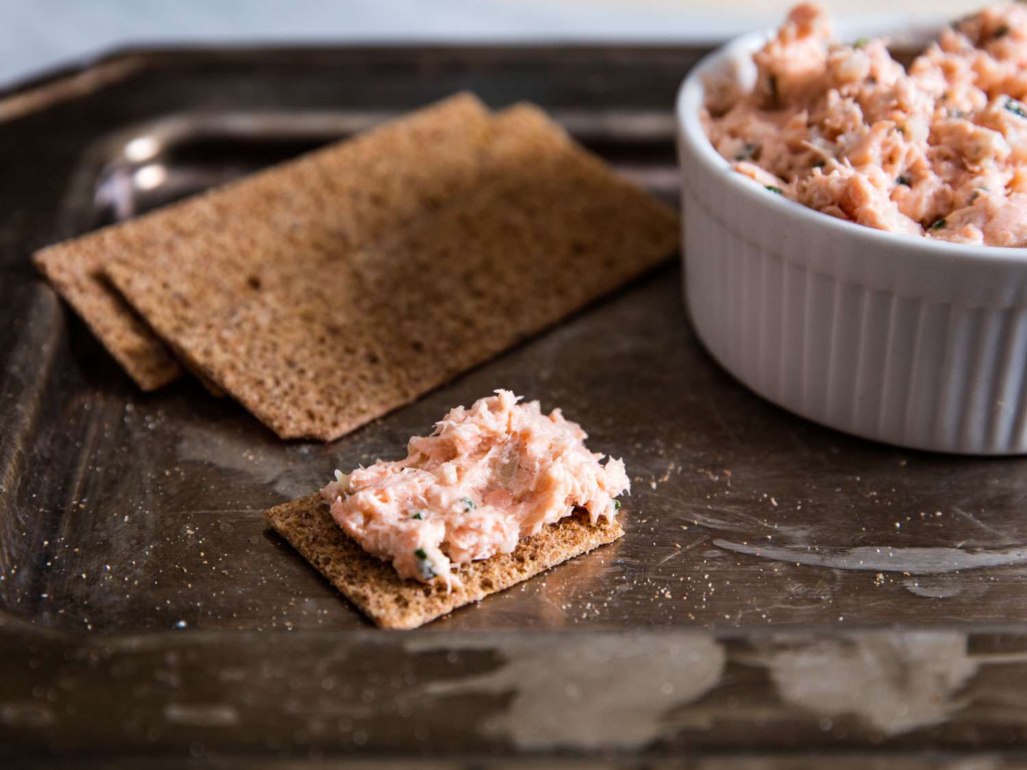 An easy appetizer of of salmon rillettes and crackers.