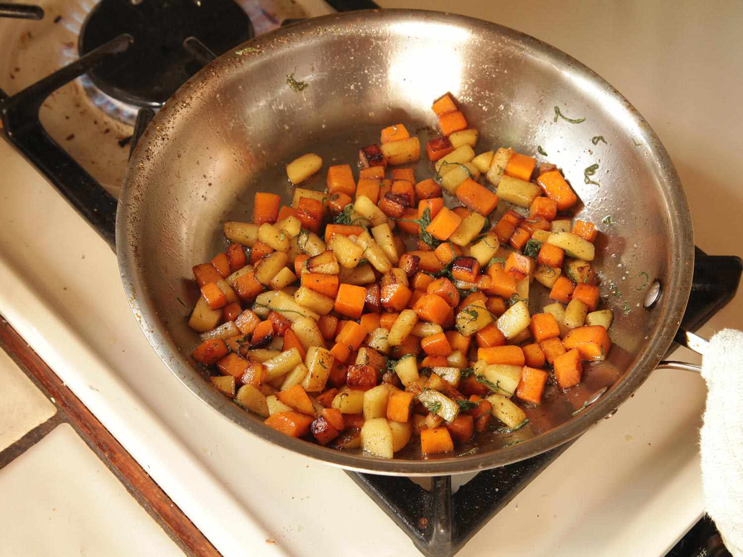 Sautéing the cubed apple and squash.