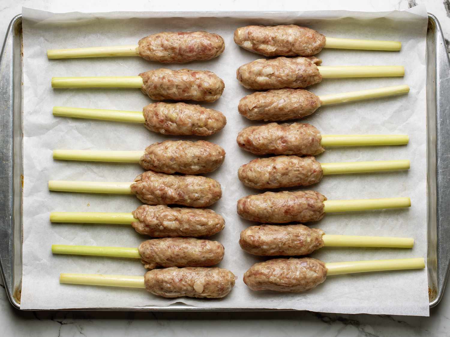 Nem lui skewers on a rimmed baking sheet lined with parchment paper