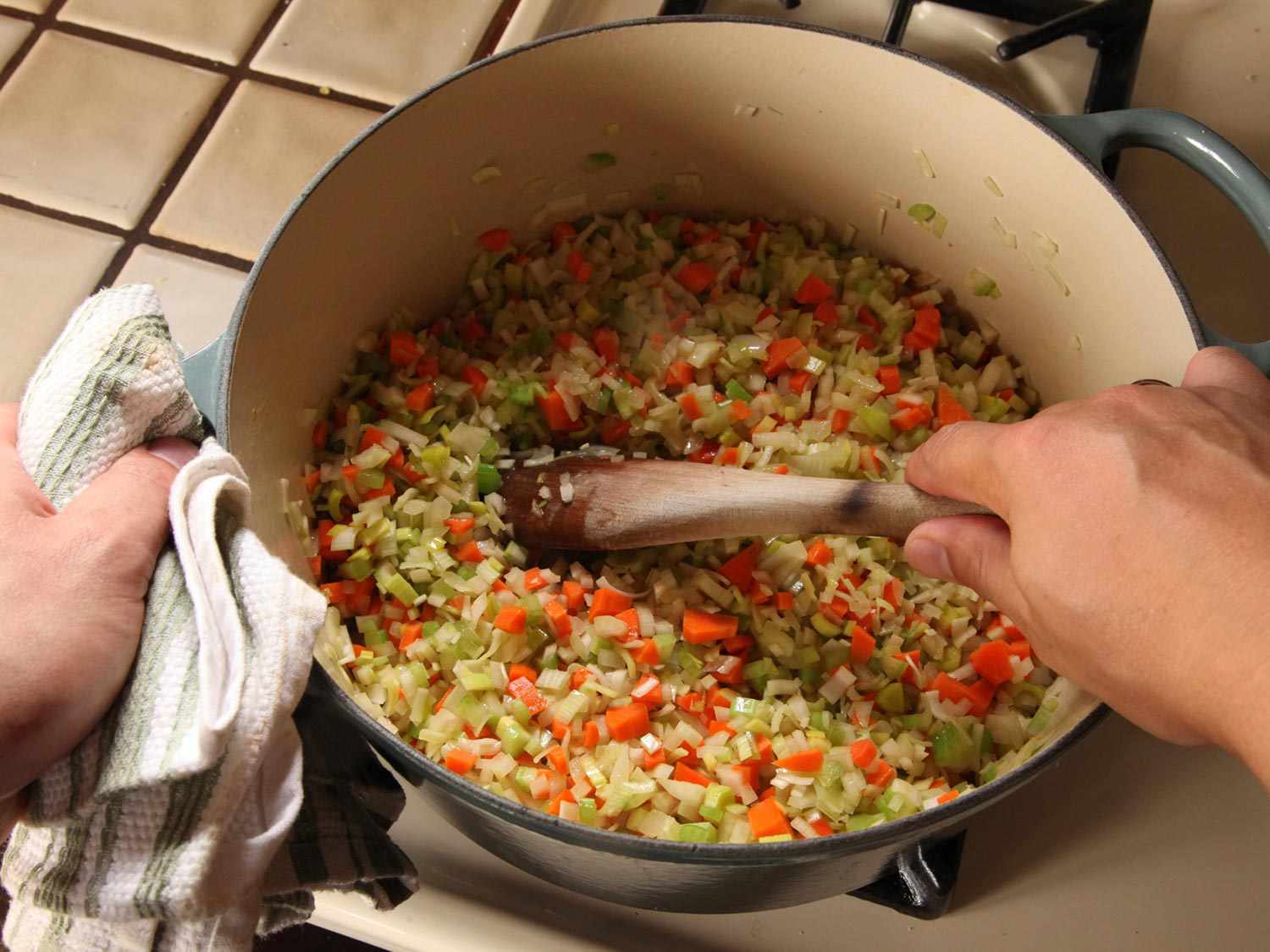 Stirring diced onion, carrot, celery, and leek together for lentil soup.
