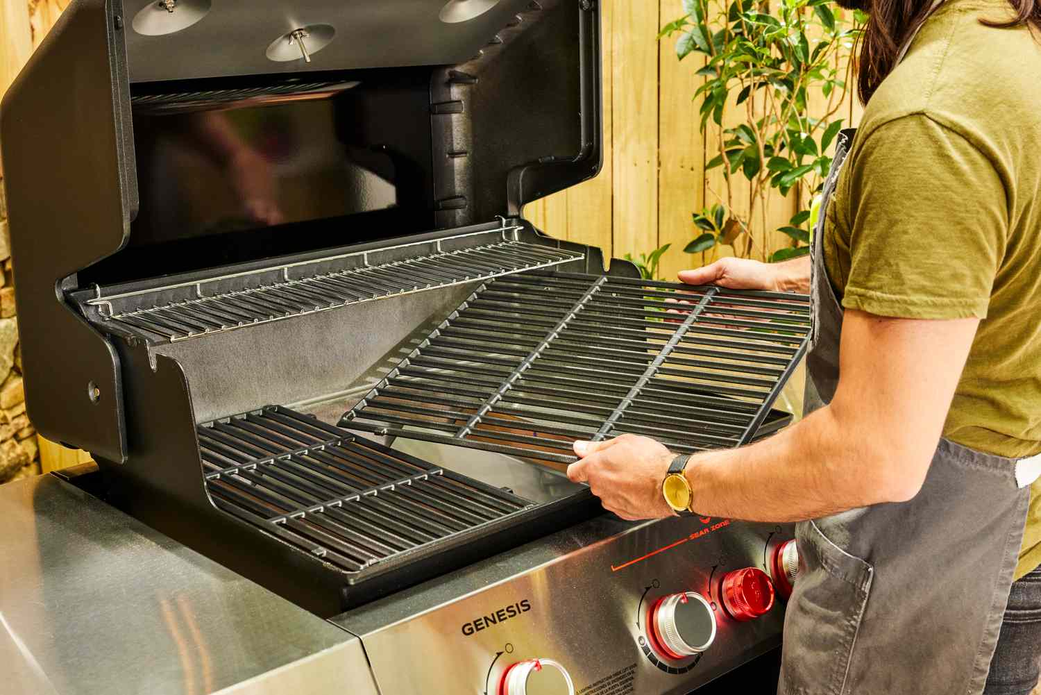 A person assembles the Weber Genesis E-325 Liquid Propane Gas Grill