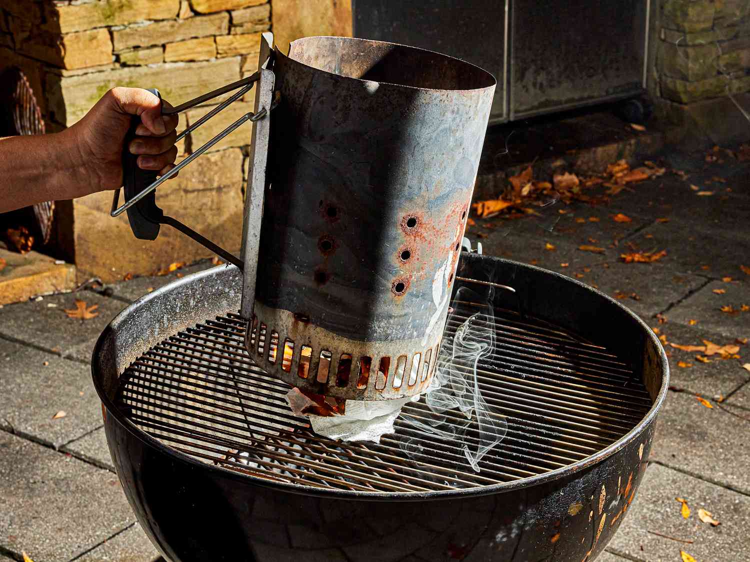 Side view of setting up charcoal grill