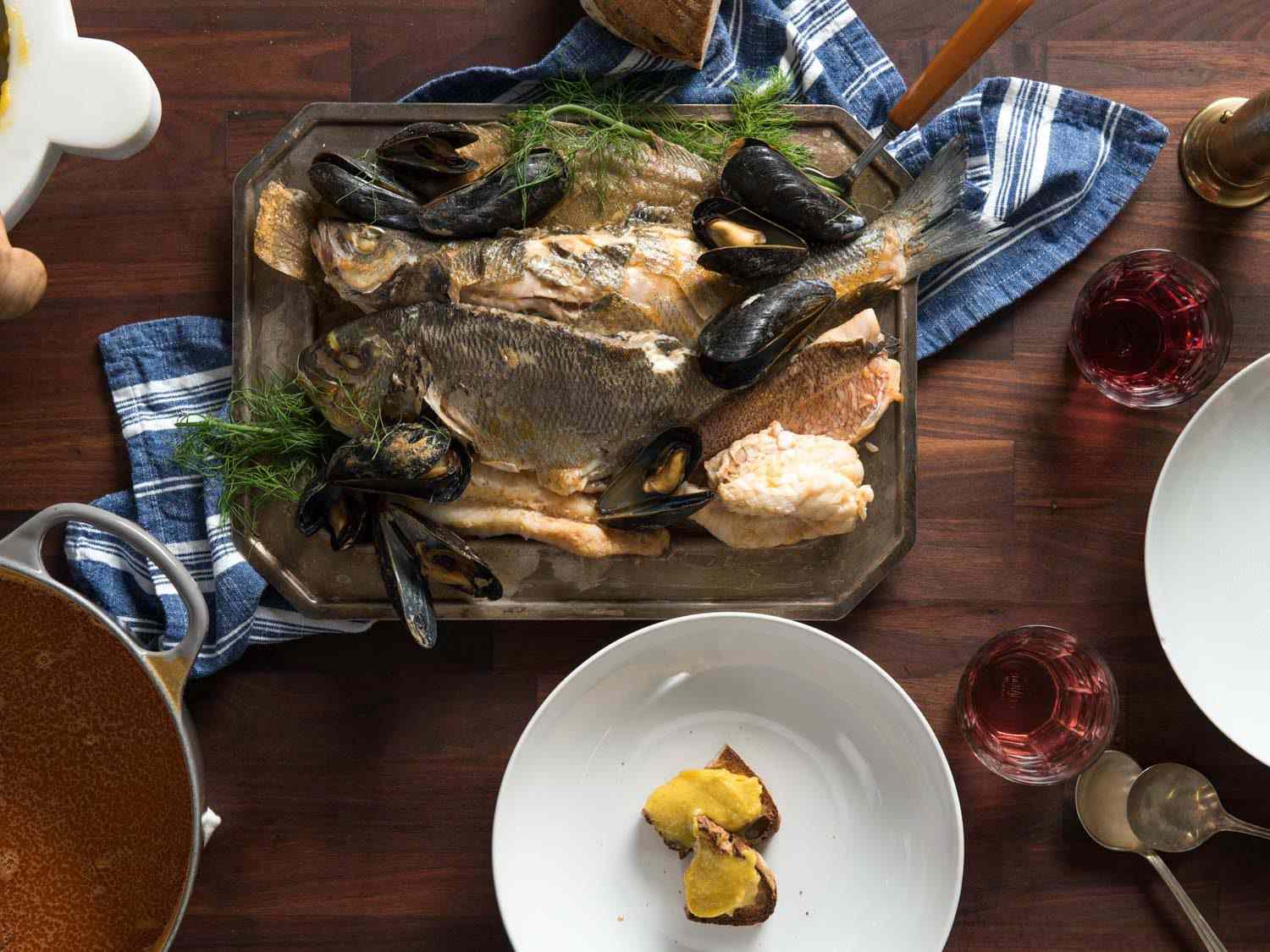 A table full of a bouillabaisse feast.