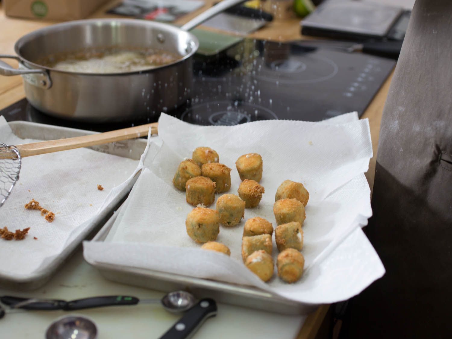 The finished poppers are drained on paper towels and showered with salt.