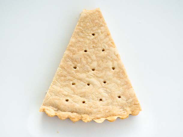 A wedge of shortbread with a bite taken out of it. 