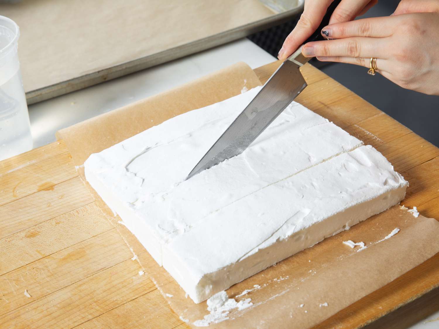 Overhead view of cutting baked meringue into squares