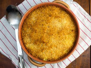 Overhead view of baked saffron risotto with mozzarella and crispy topping.