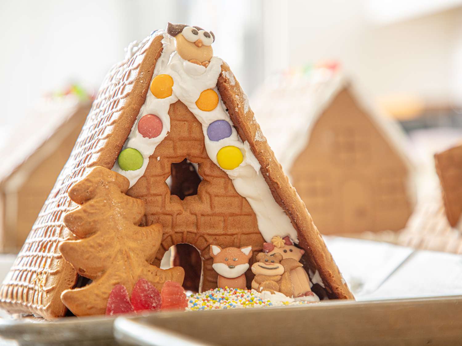 Decorated gingerbread house with holidaythemed icing and small decorative candies