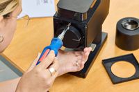 A person assembles the Fellow Ode Gen 2 Coffee Grinder