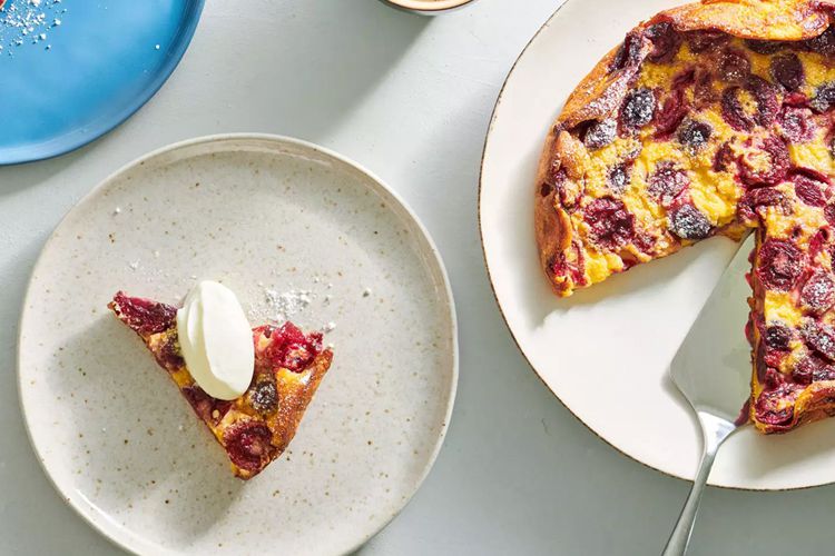 A slice of Cherry clafoutis next to the remainder of the pie
