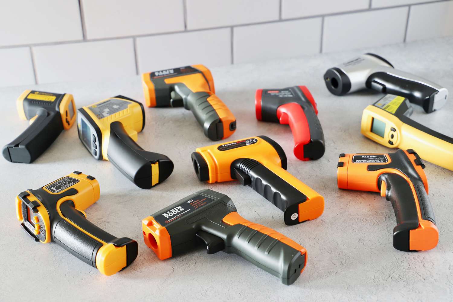 a group of infared thermometers on a grey kitchen countertop