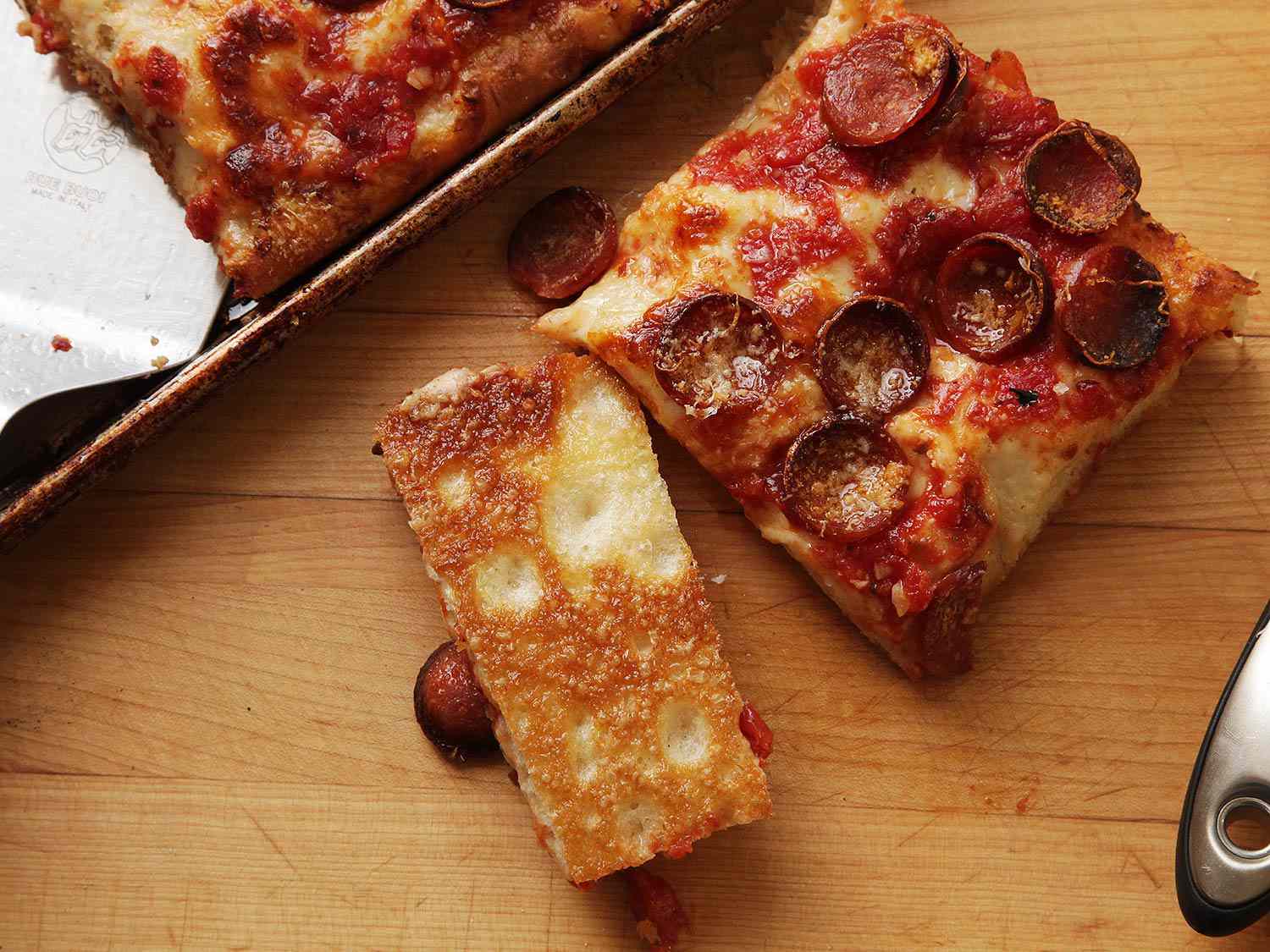 Image showing the crispy underside of a slice of Sicilian-style pizza