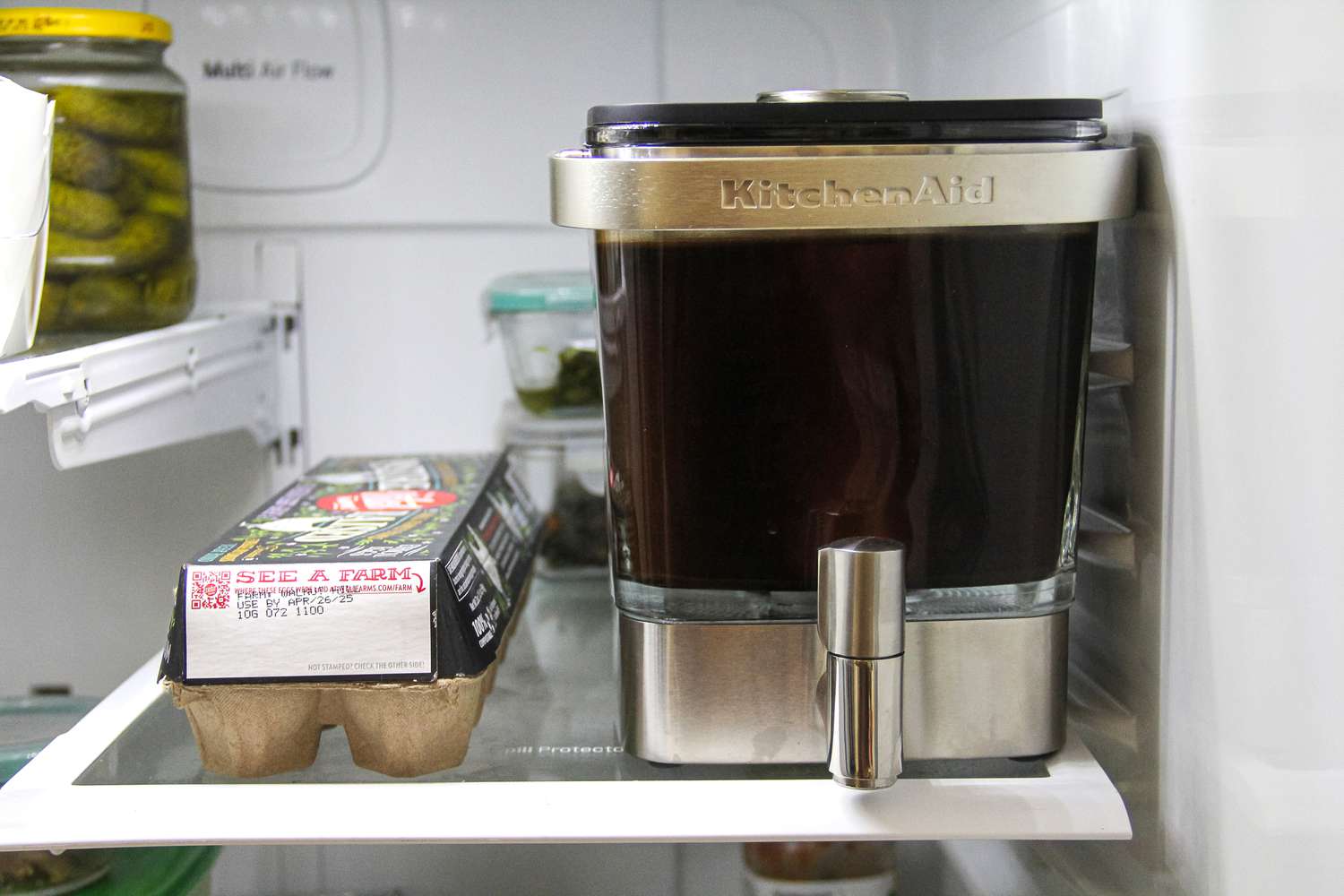 The KitchenAid cold brew maker on a fridge shelf.