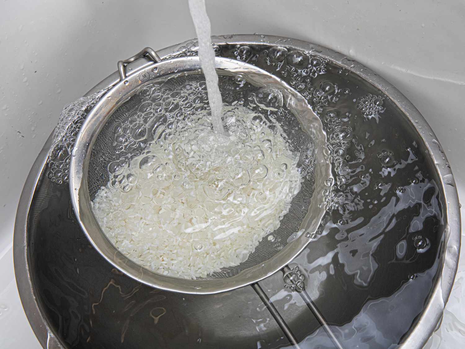 Water overflowing a bowl under rice