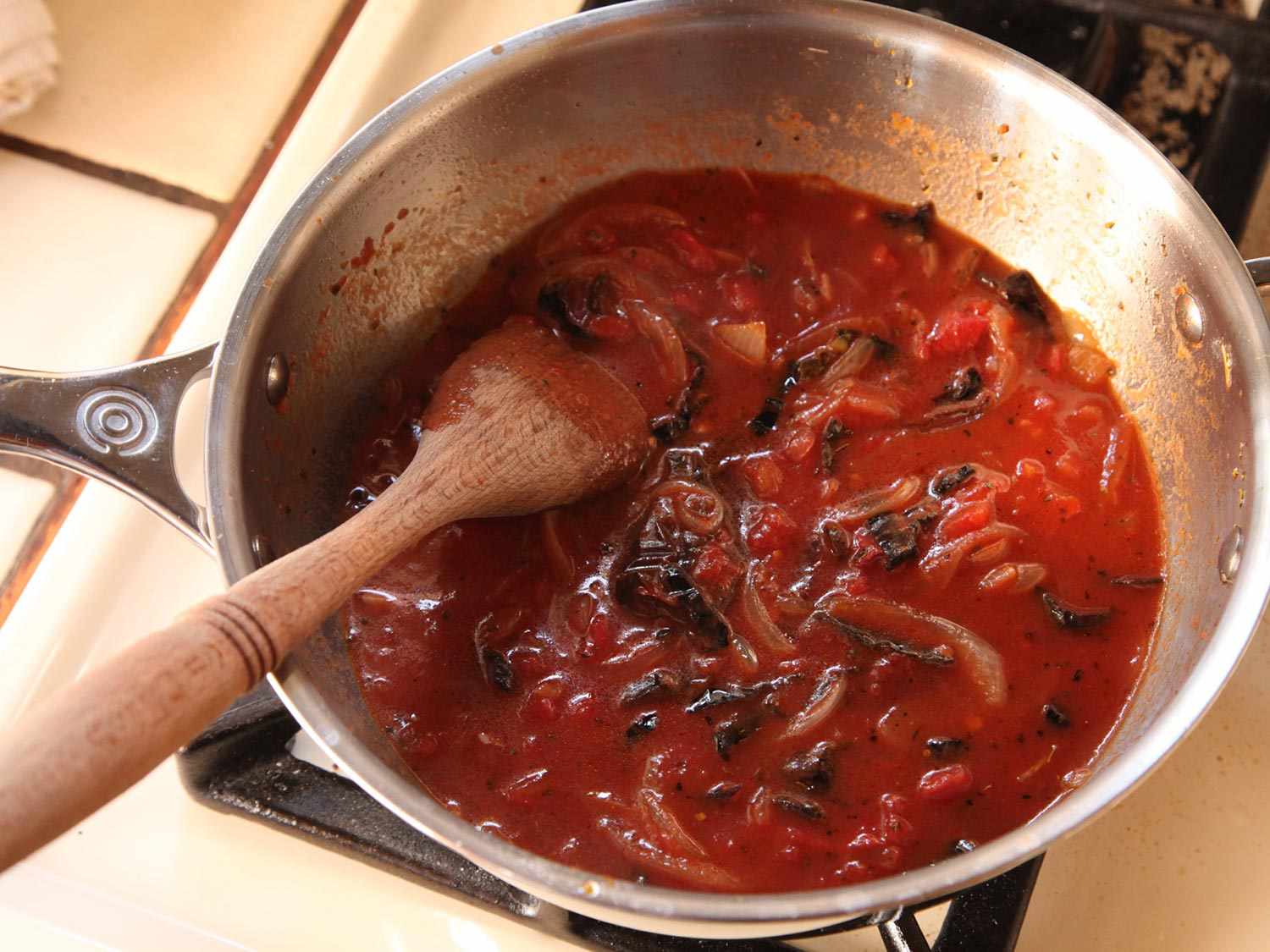 A small pot of simmering tomato chile salsa for huevos rancheros.