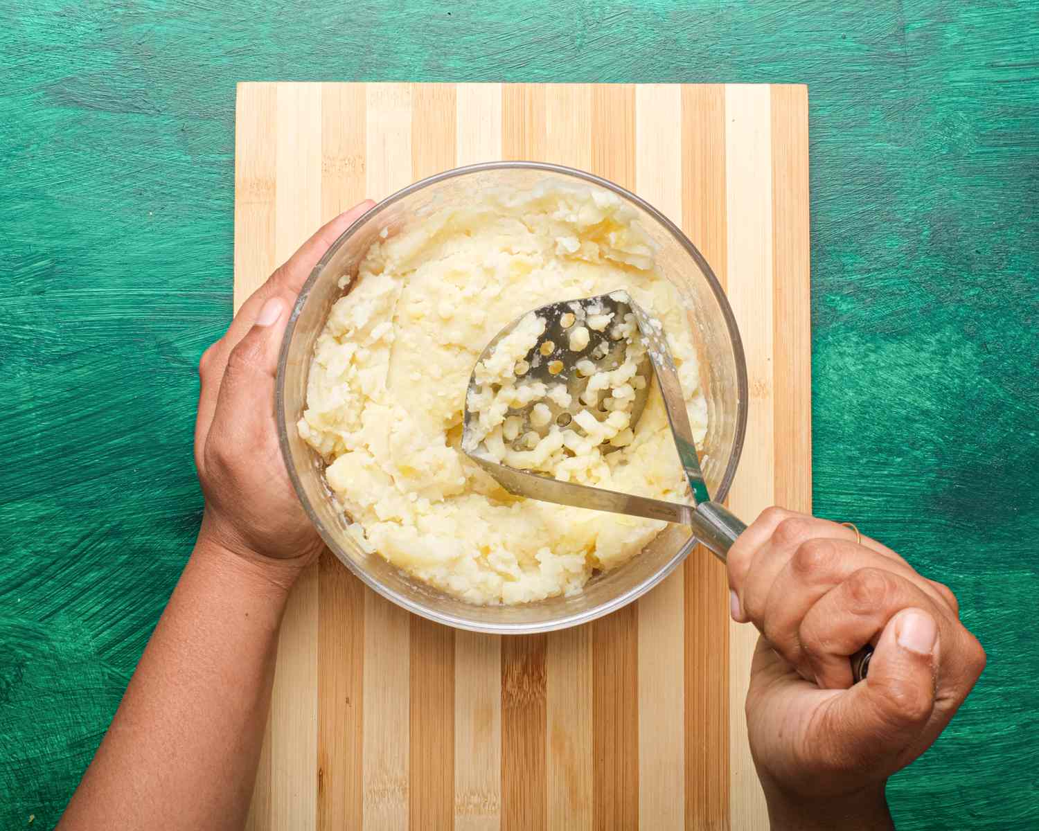 Overhead view of mashing potatoes