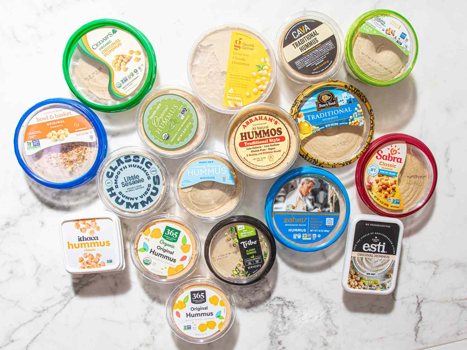 A variety of hummus containers displayed on a white background
