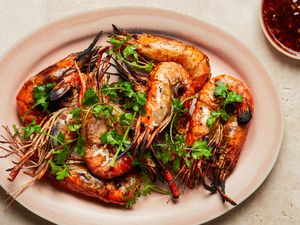 Grilled prawns with herbs and a side of sauce