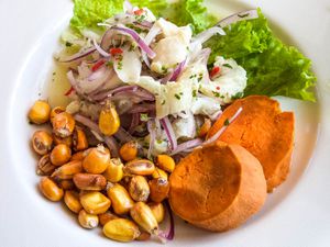 A platter of Peruvian ceviche with boiled corn and sweet potato.