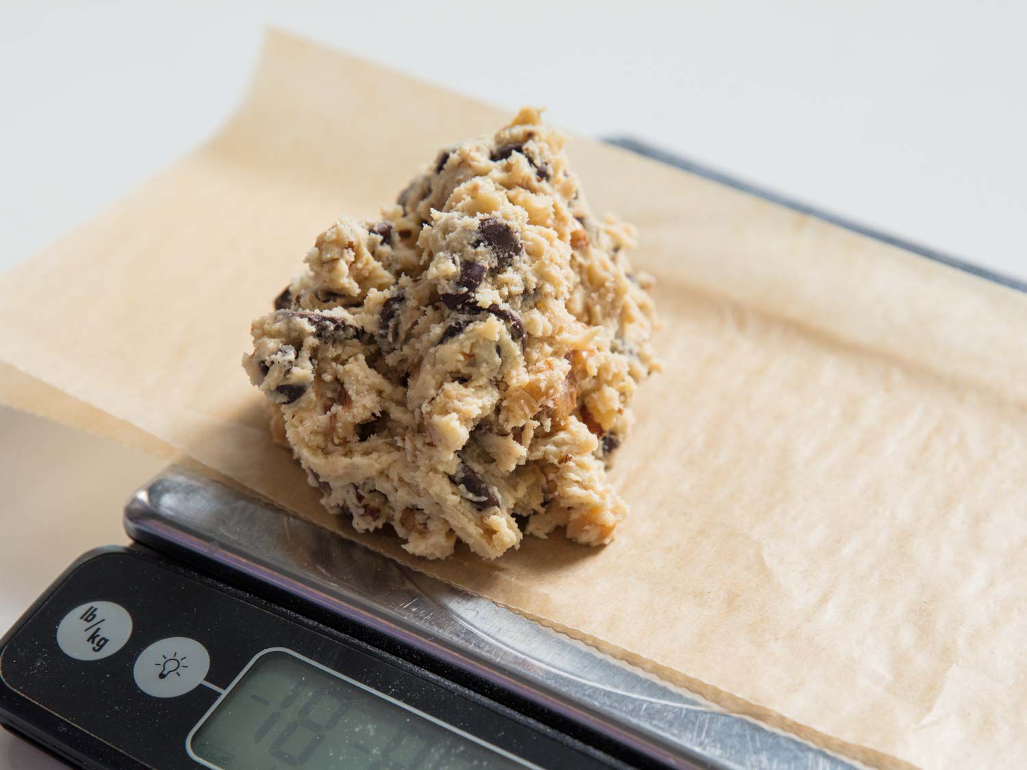 A large portion of dough being measured on a scale.
