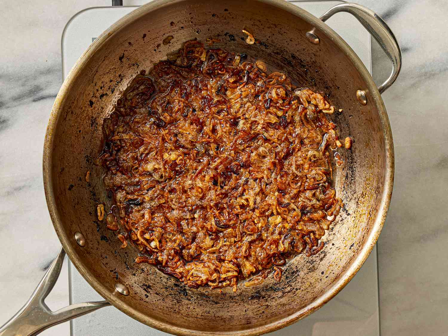 Overhead view of shallots cooking