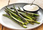Dry-charred asparagus, served on an earthenware plate with a ramekin of miso bearnaise.
